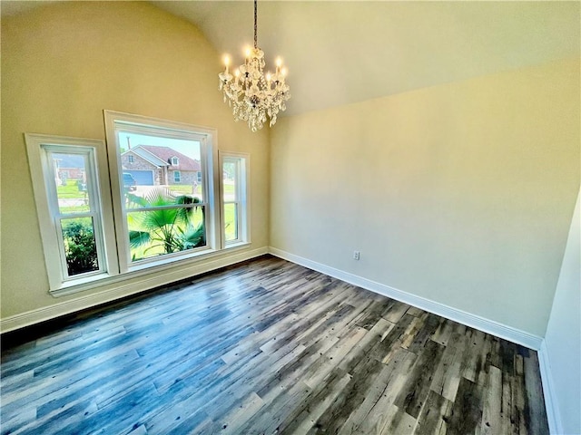 unfurnished dining area featuring lofted ceiling, a notable chandelier, baseboards, and dark wood-type flooring