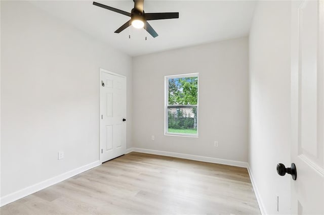 empty room featuring light wood-style flooring, baseboards, and ceiling fan