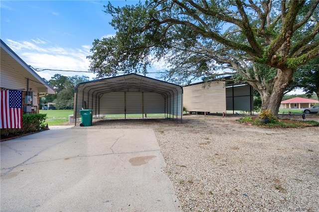 garage featuring driveway and a carport