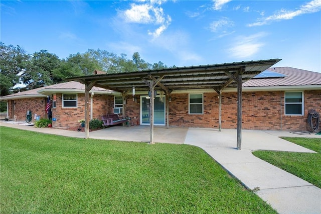 ranch-style home featuring metal roof, a front lawn, and brick siding