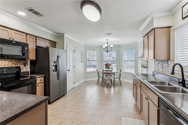 kitchen featuring dark countertops, visible vents, ornamental molding, a sink, and black appliances