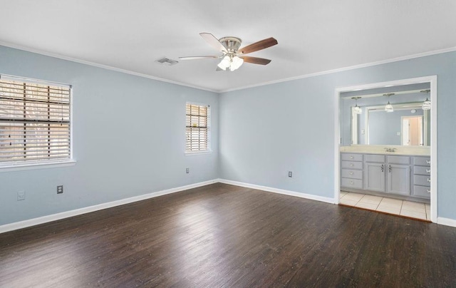 unfurnished bedroom featuring light wood-type flooring, visible vents, baseboards, and crown molding