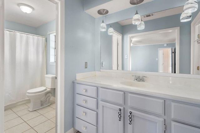 bathroom featuring curtained shower, visible vents, toilet, vanity, and tile patterned floors