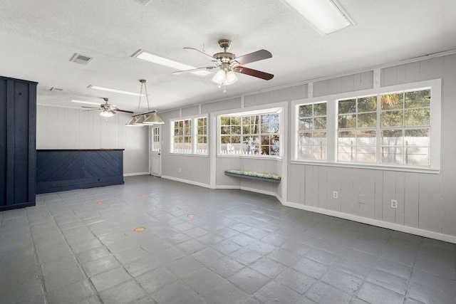 spare room featuring ceiling fan, a textured ceiling, visible vents, and tile patterned floors