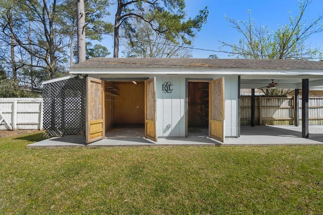 view of outdoor structure featuring an outbuilding and fence