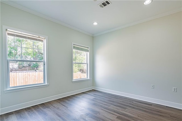 unfurnished room with baseboards, visible vents, dark wood-type flooring, crown molding, and recessed lighting