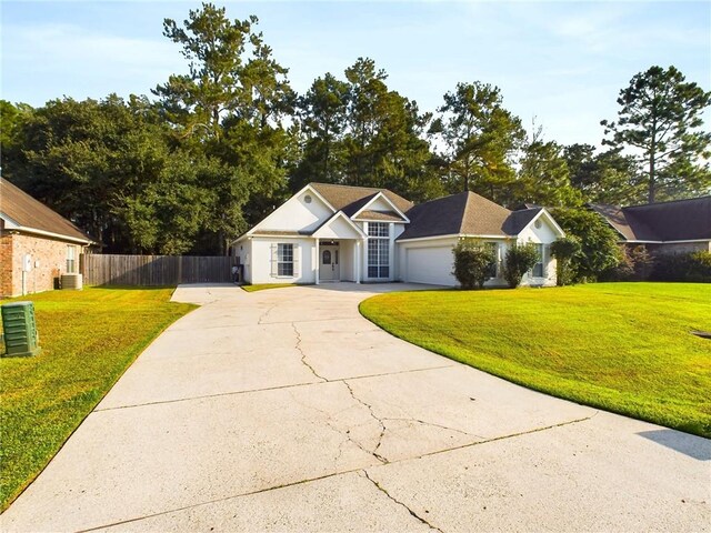 ranch-style home with driveway, a garage, fence, central air condition unit, and a front lawn