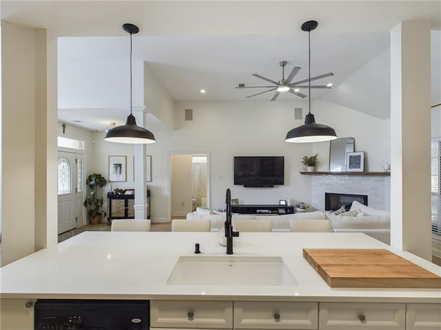 kitchen with dishwasher, open floor plan, a sink, and light countertops