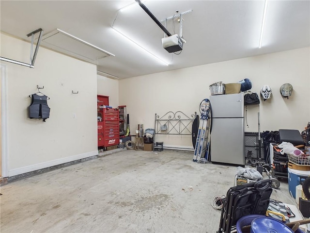 garage with freestanding refrigerator and a garage door opener