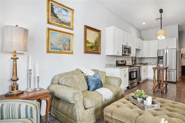 living area with recessed lighting, dark wood-style floors, and visible vents