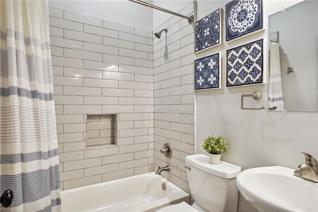 bathroom featuring toilet, shower / bath combo with shower curtain, and a sink