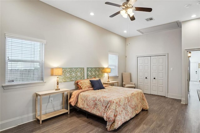 bedroom with a closet, visible vents, attic access, and wood finished floors