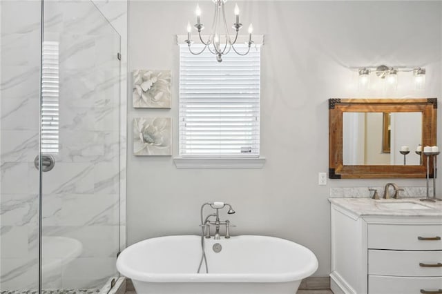 bathroom featuring a marble finish shower, a soaking tub, and vanity