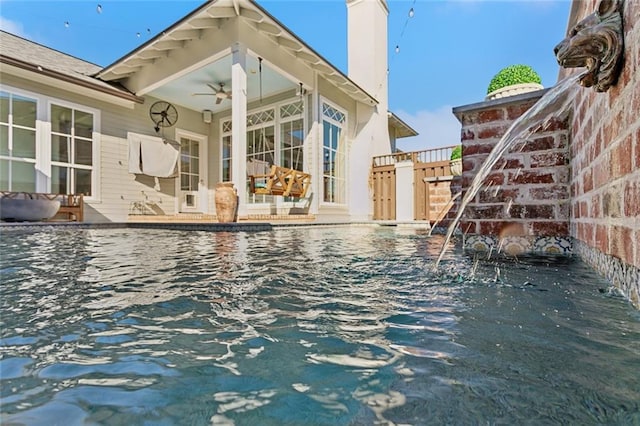 view of swimming pool featuring a ceiling fan