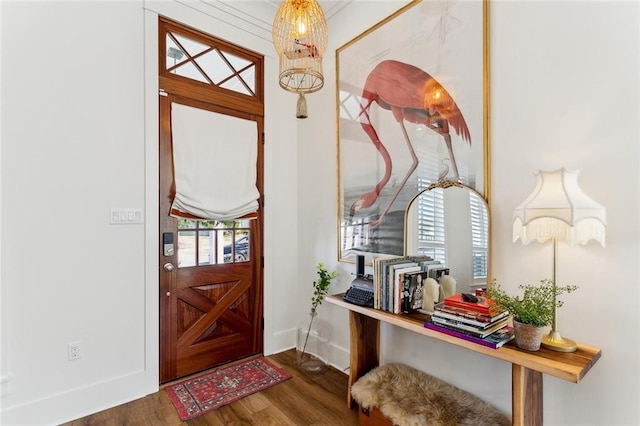 foyer featuring baseboards and wood finished floors