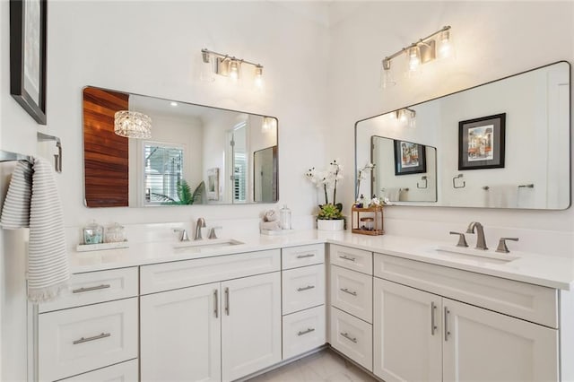 bathroom with marble finish floor, a sink, and double vanity