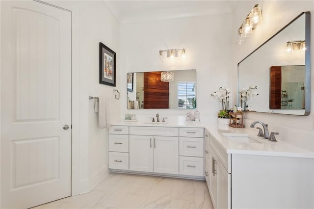 bathroom featuring marble finish floor, crown molding, and vanity