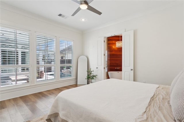 bedroom featuring ceiling fan, recessed lighting, crown molding, and wood finished floors