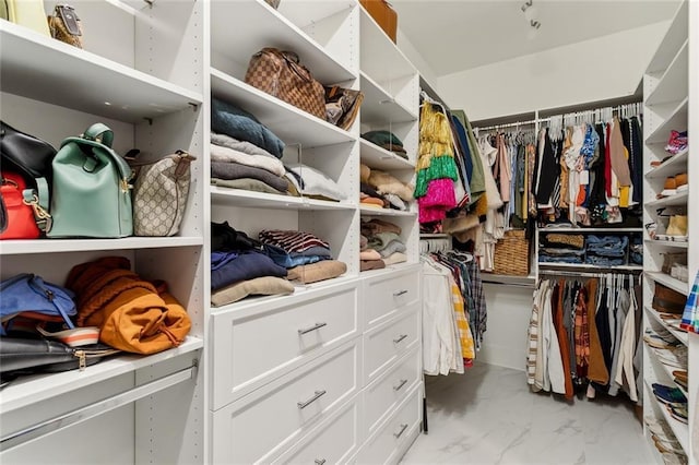 spacious closet featuring marble finish floor