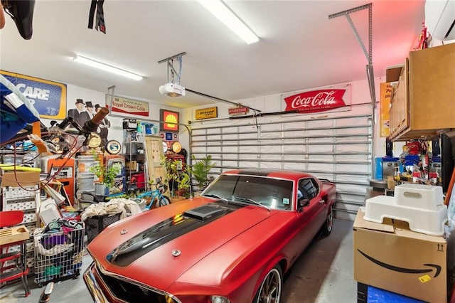 garage featuring a wall mounted AC and a garage door opener