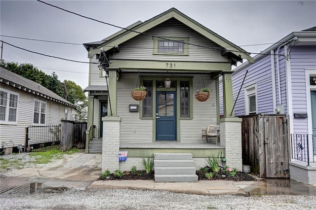 shotgun-style home featuring a porch