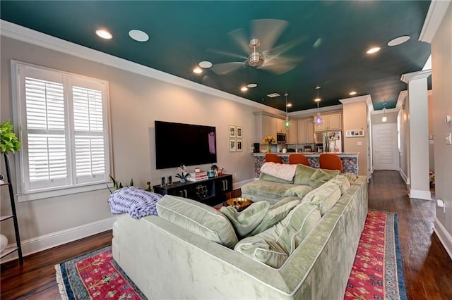 living room featuring dark wood-style floors, baseboards, and ornamental molding