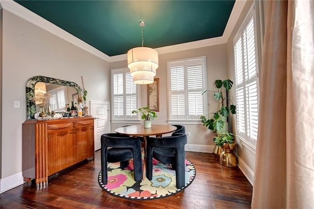 dining space featuring dark wood-style floors, ornamental molding, and baseboards