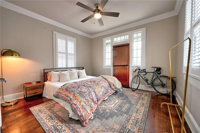 bedroom featuring multiple windows, wood finished floors, and crown molding