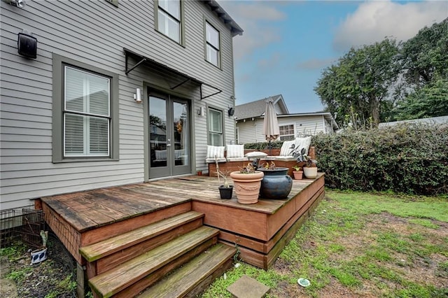 wooden deck with french doors and a yard