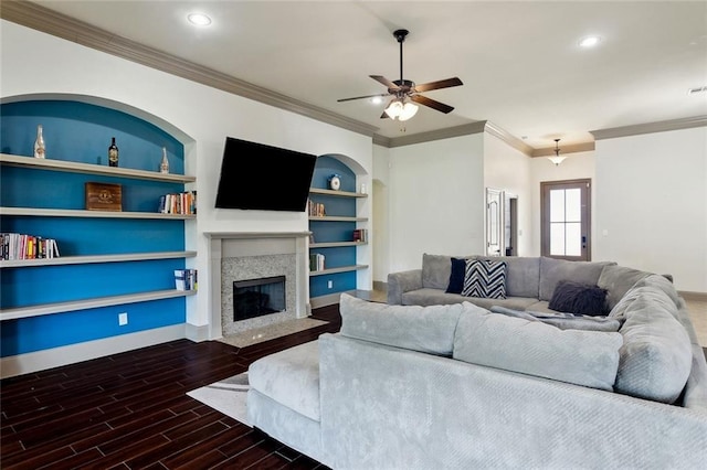 living room with a premium fireplace, baseboards, wood finished floors, and recessed lighting