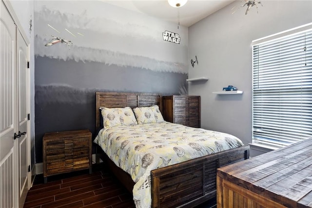 bedroom with a closet and wood tiled floor