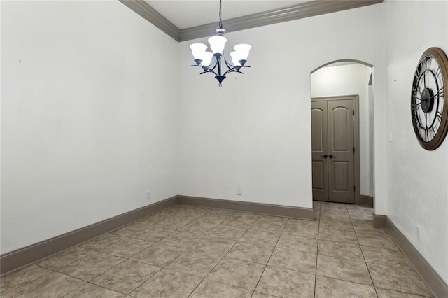 unfurnished room with arched walkways, a notable chandelier, crown molding, and baseboards