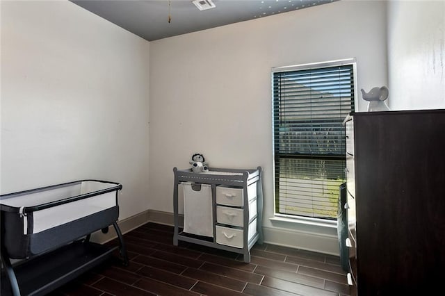 misc room featuring wood finish floors, visible vents, and baseboards