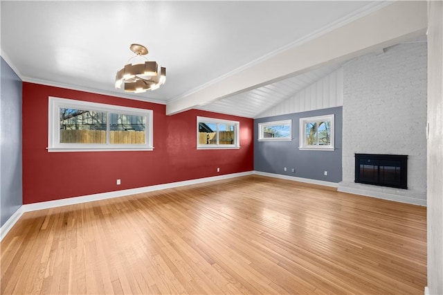 unfurnished living room featuring lofted ceiling, light wood-style floors, a fireplace, and baseboards