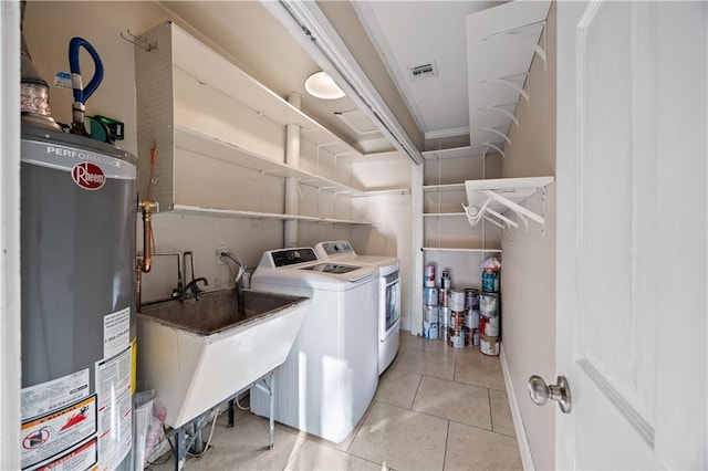 laundry room with laundry area, visible vents, independent washer and dryer, gas water heater, and light tile patterned flooring