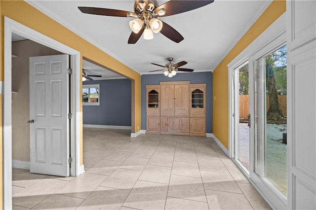 entryway with light tile patterned flooring, crown molding, and baseboards