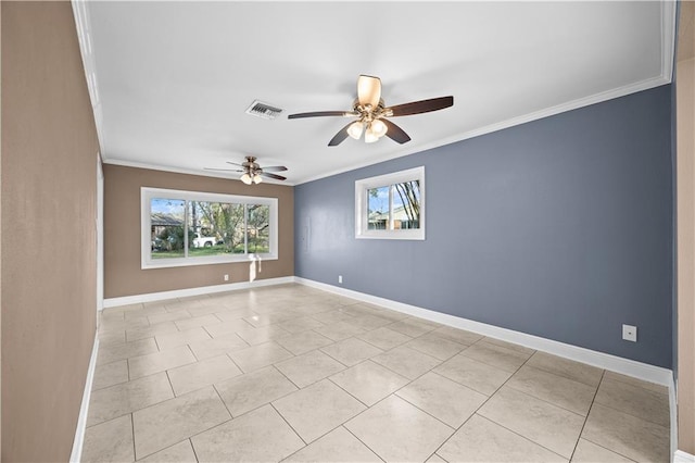 empty room featuring crown molding and baseboards