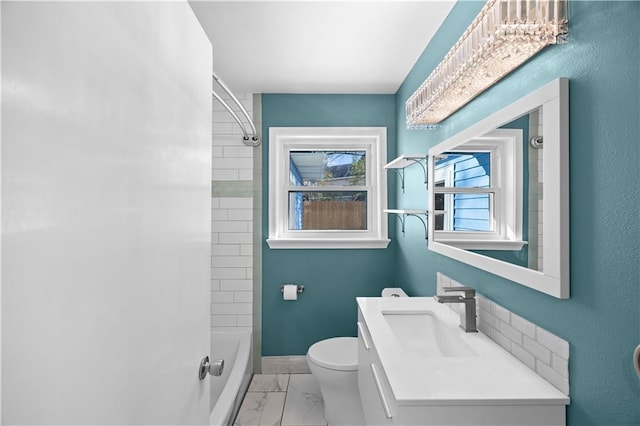 bathroom featuring baseboards, toilet, marble finish floor, vanity, and washtub / shower combination