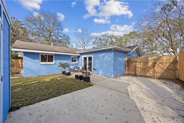 back of house with a gate and fence