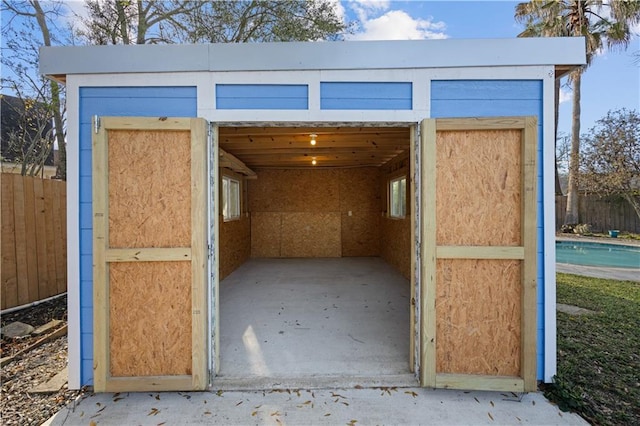 view of shed with fence