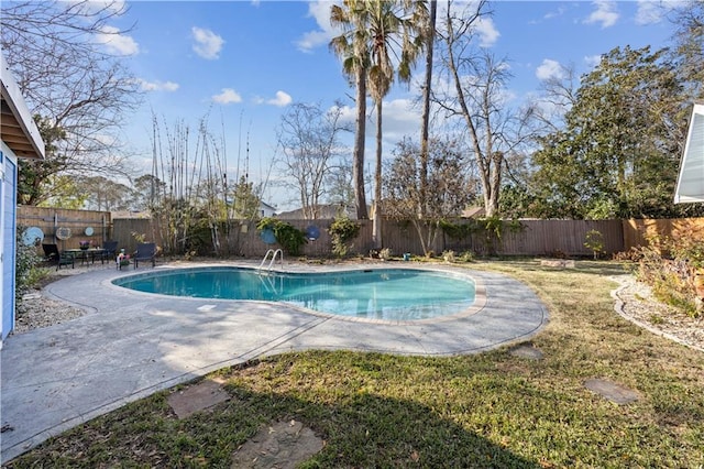 view of pool featuring a yard, a patio area, a fenced backyard, and a fenced in pool