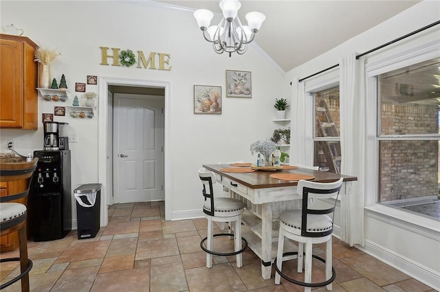 dining area featuring lofted ceiling, an inviting chandelier, and baseboards