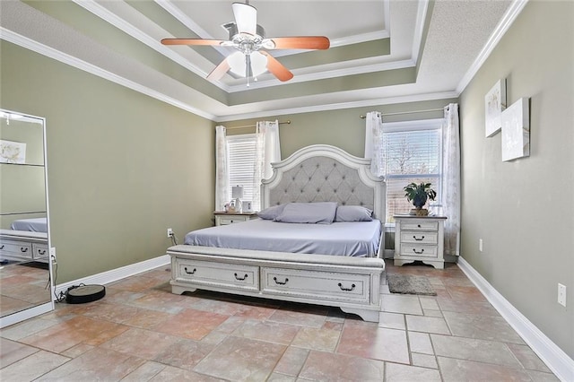 bedroom featuring a ceiling fan, a raised ceiling, crown molding, and baseboards