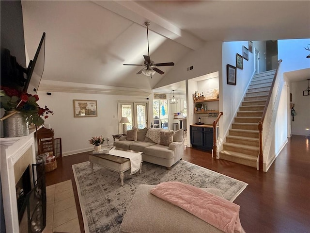living room with visible vents, a fireplace, ceiling fan, stairway, and beam ceiling