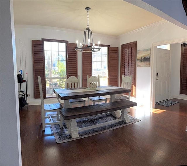 dining room featuring an inviting chandelier, ornamental molding, baseboards, and wood finished floors