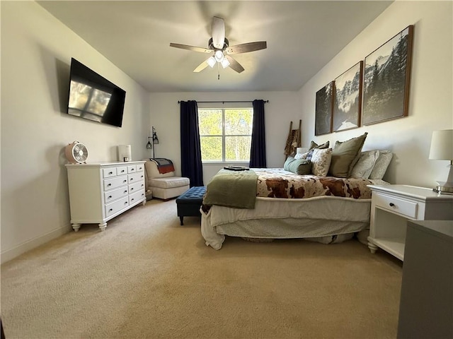 carpeted bedroom featuring baseboards and a ceiling fan