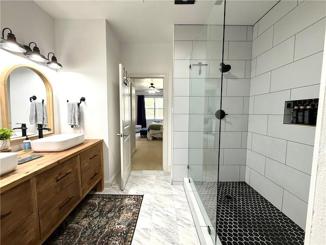 ensuite bathroom with marble finish floor, a sink, double vanity, and a walk in shower