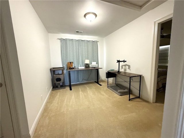 office area featuring baseboards, visible vents, and light colored carpet