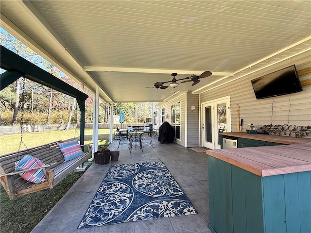 view of patio / terrace with a ceiling fan, outdoor dining space, a grill, and fence