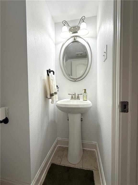 bathroom featuring tile patterned flooring and baseboards